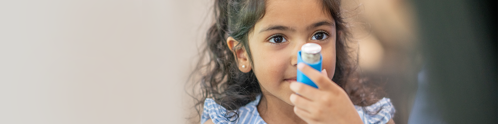 child using an inhaler 