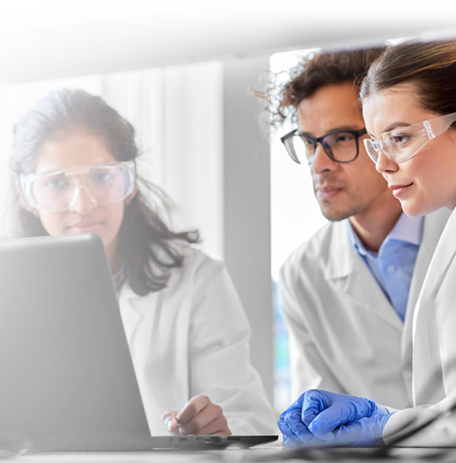 Scientists looking at a computer in a lab