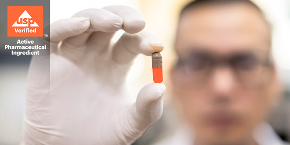 scientist holding pill